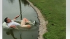 Golfer falls into pond after a daring shot