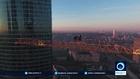 Daredevils climb up crane in Moscow