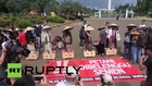 Indonesia: Eco-protesters cement feet by state palace, won't move til they see president
