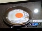 Reporter Cooks Egg on Pan Lying on a Road