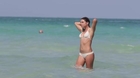 Surfer babe Anastasia Ashley swims in a white bikini